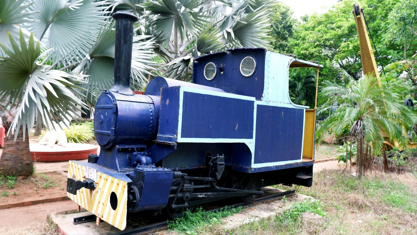 a blue and yellow train sitting on top of a train track